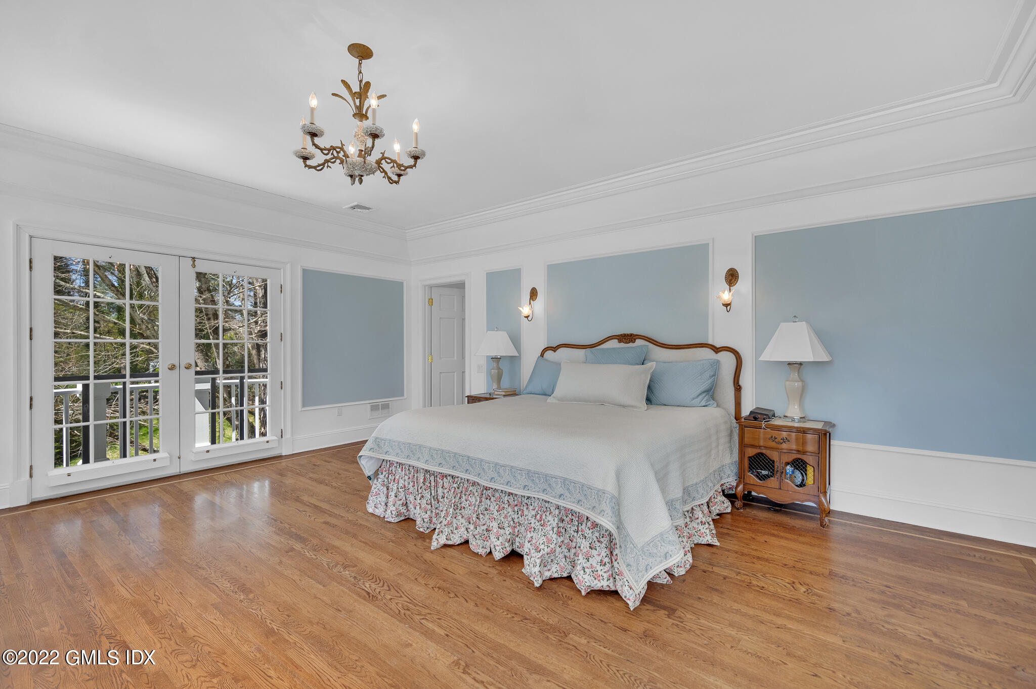 280 Round Hill Road Greenwich, CT 06831 - Photo 17 of 35 a spacious bedroom with a bed chandelier and a window