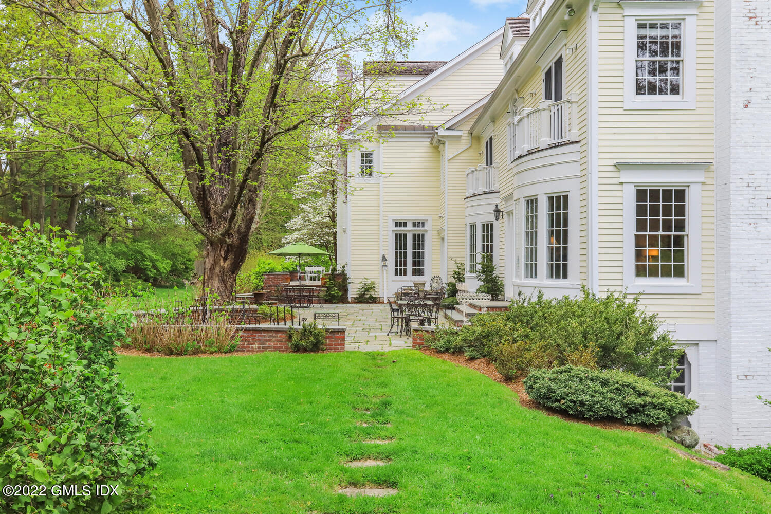 280 Round Hill Road Greenwich, CT 06831 - Photo 23 of 35 a view of a house with a backyard and a patio