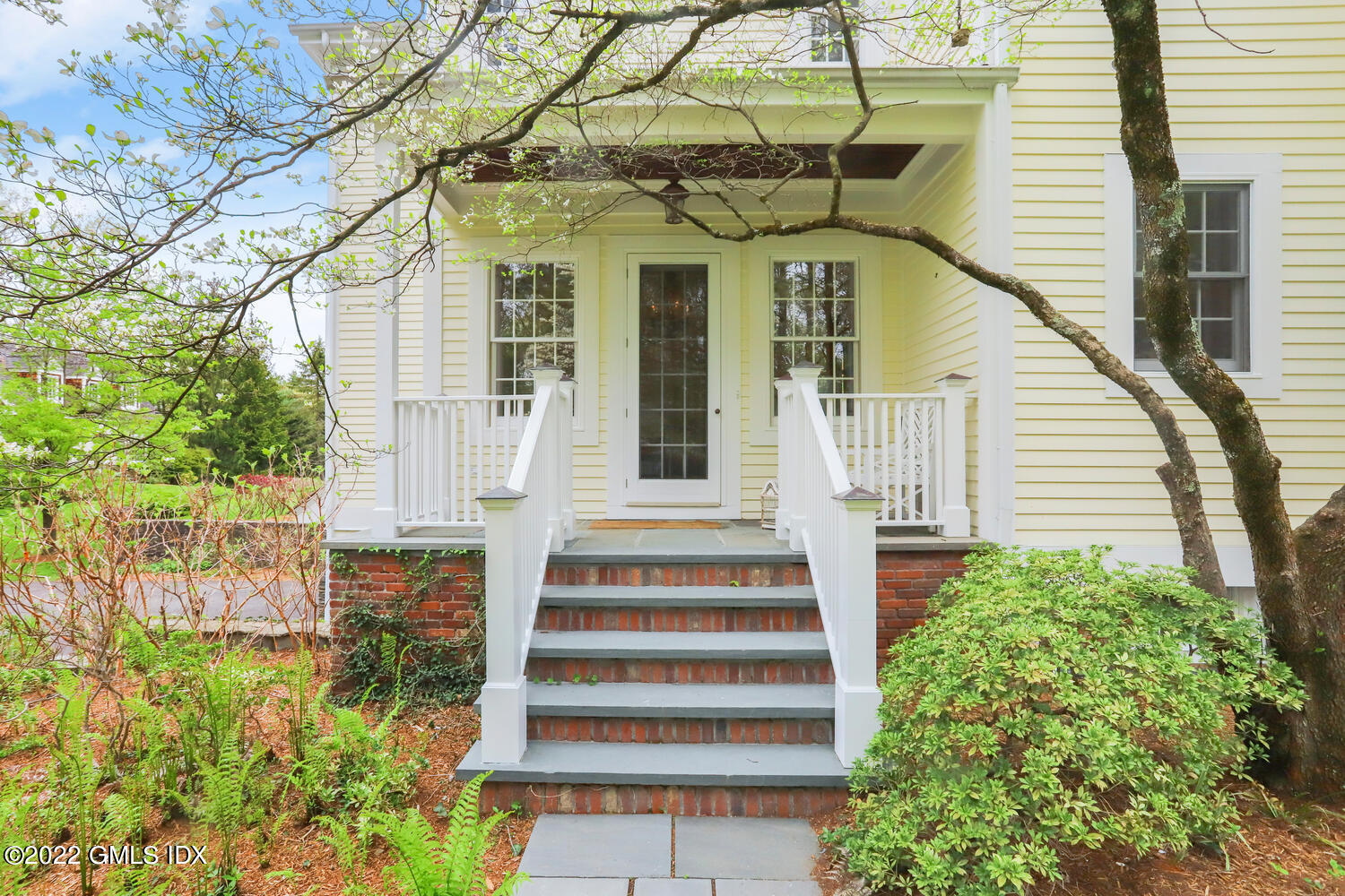 280 Round Hill Road Greenwich, CT 06831 - Photo 25 of 35 a front view of a house with a garden