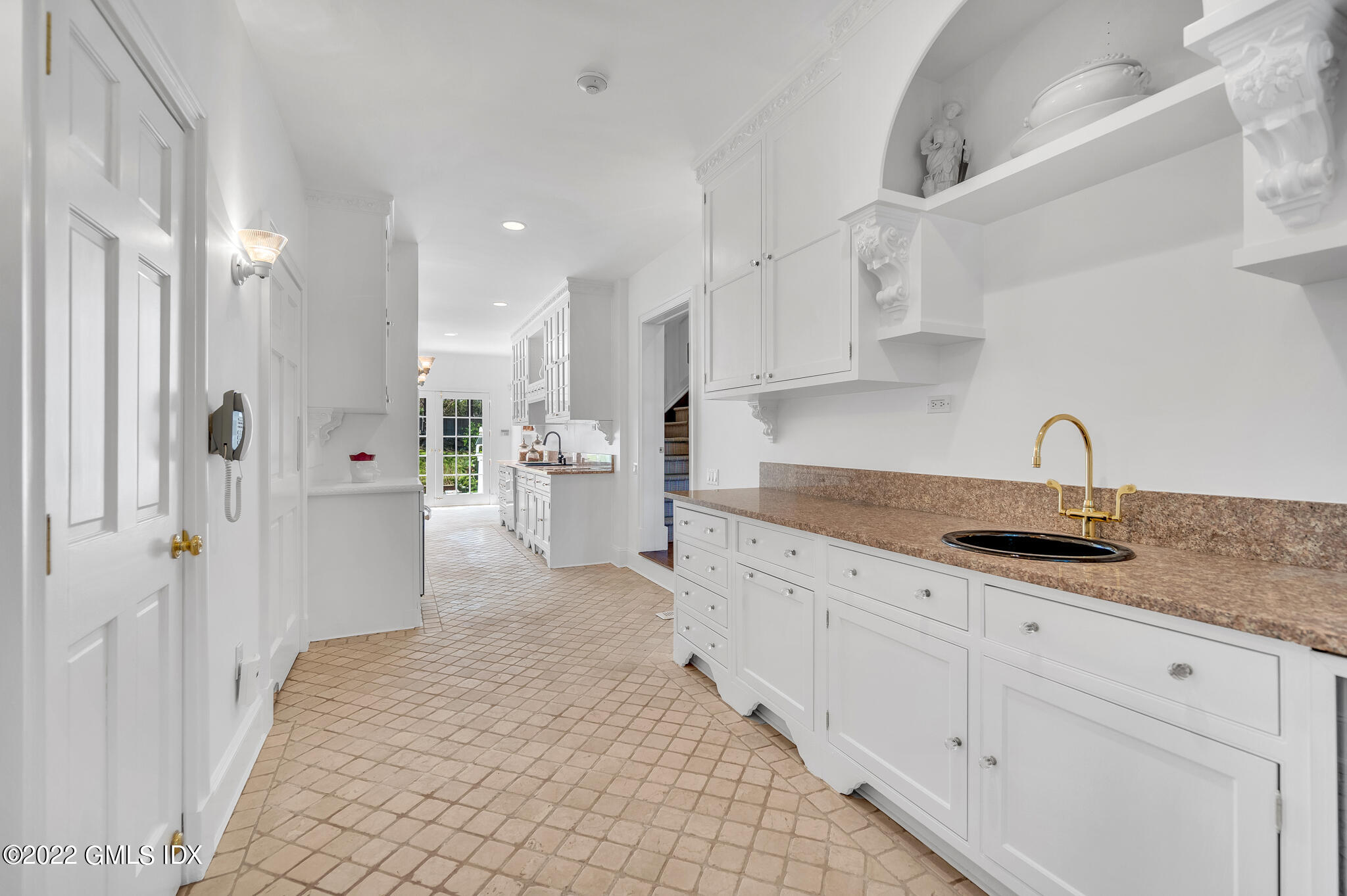 280 Round Hill Road Greenwich, CT 06831 - Photo 10 of 35 a kitchen with granite countertop a sink and white cabinets