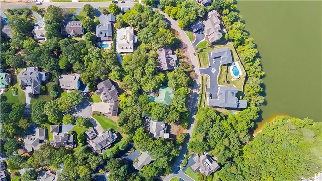 an aerial view of a houses with a lake view
