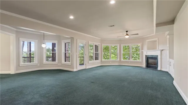 a view of a tennis ground with large trees