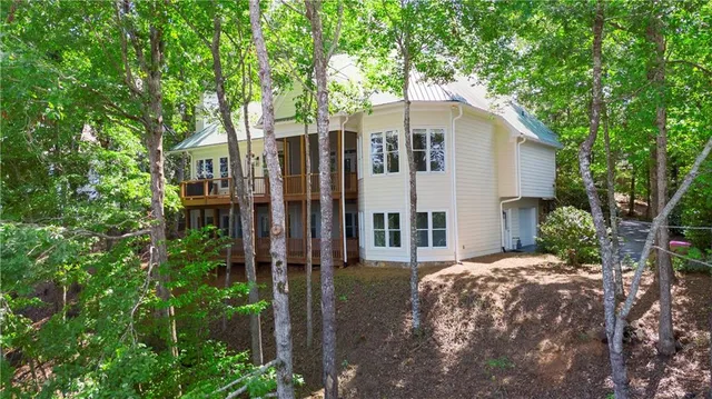 a view of empty room with window and wooden floor