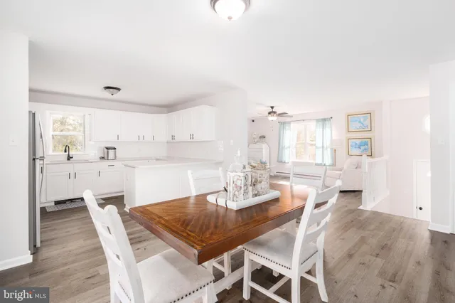 a dining room with furniture and wooden floor
