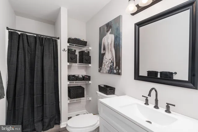 a bathroom with a toilet a sink and a mirror