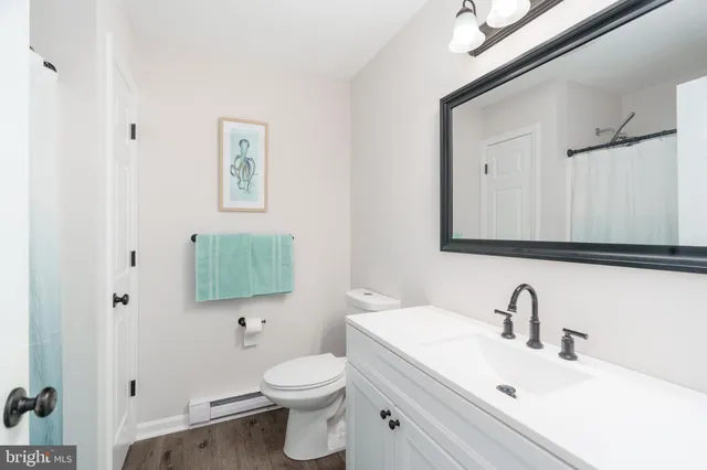 a bathroom with a toilet sink and mirror