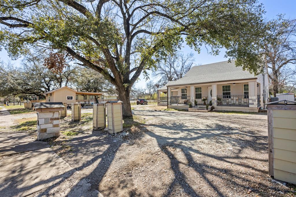 811 Ward Street Marlin, TX 76661 - Photo 30 of 31 Back of property with a shingled roof and covered porch