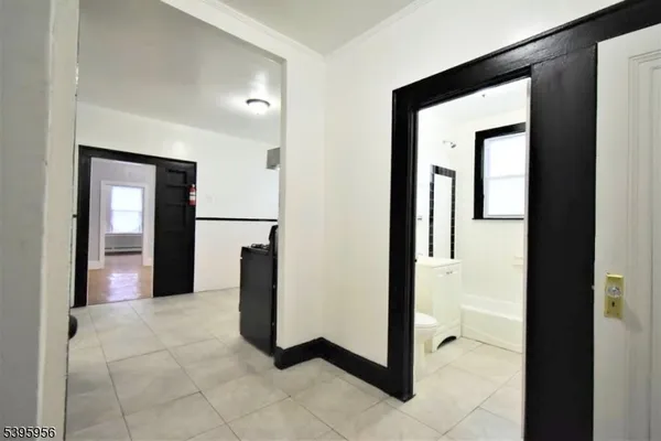 a view of a hallway with entryway and stairs