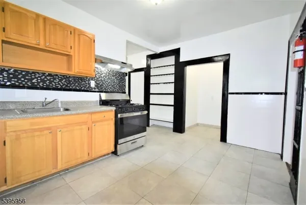 a kitchen with stainless steel appliances granite countertop a refrigerator sink and cabinets