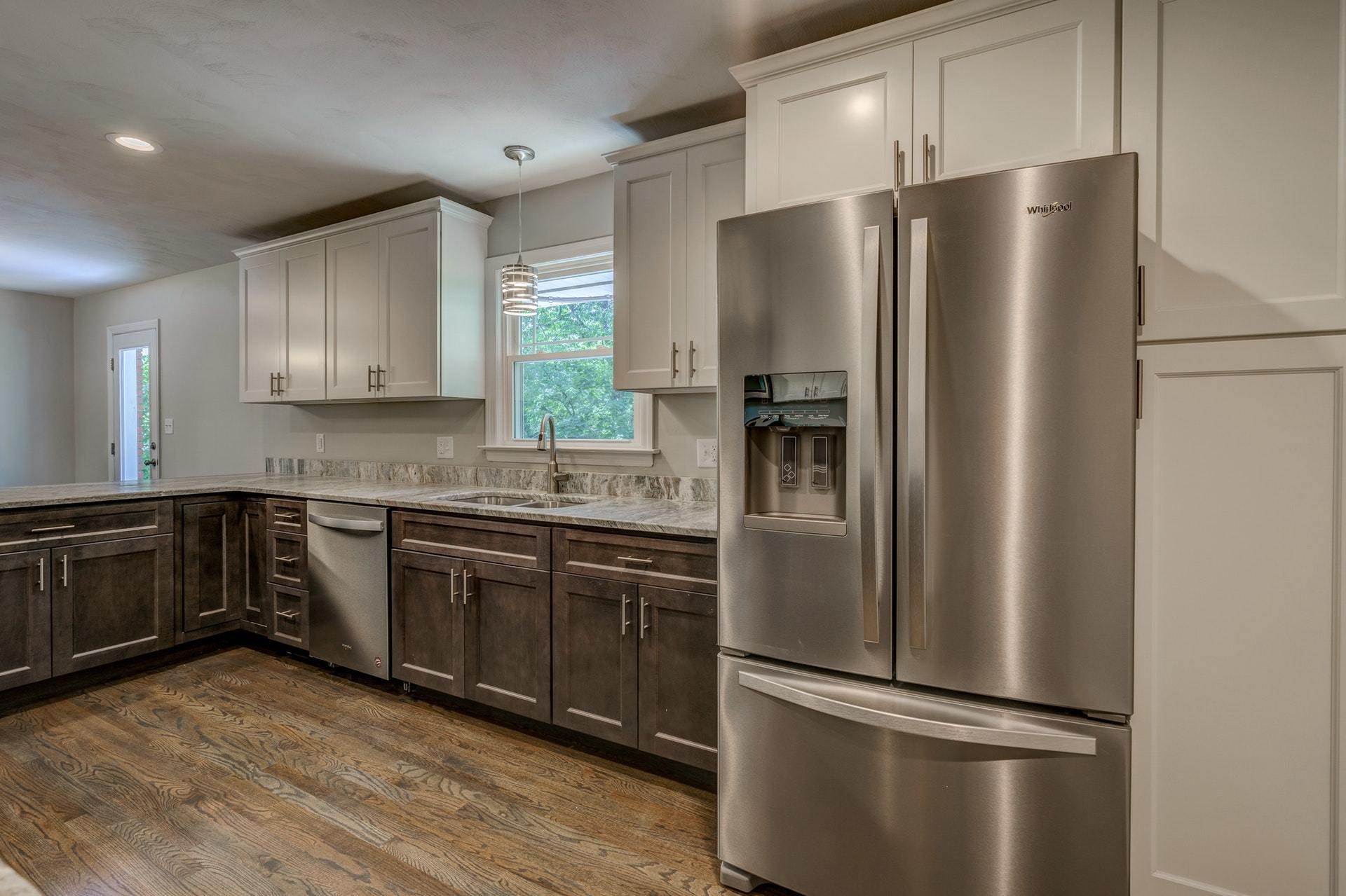 3585 Forester Road Southwest Roanoke, VA 24018 - Photo 11 of 38 a kitchen with stainless steel appliances granite countertop a refrigerator a sink a stove a microwave and wooden cabinets