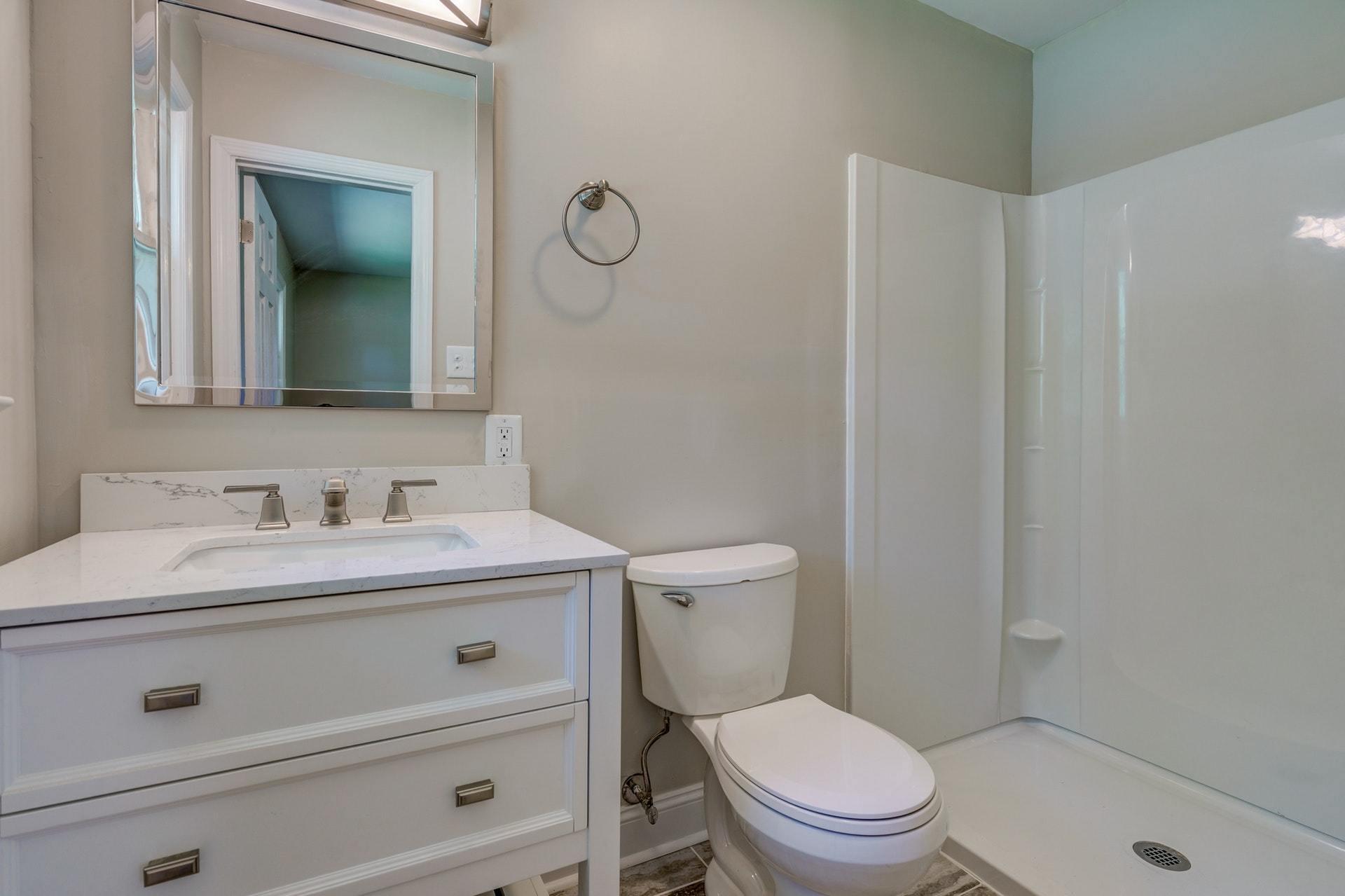 3585 Forester Road Southwest Roanoke, VA 24018 - Photo 21 of 38 a bathroom with a granite countertop toilet sink vanity and mirror