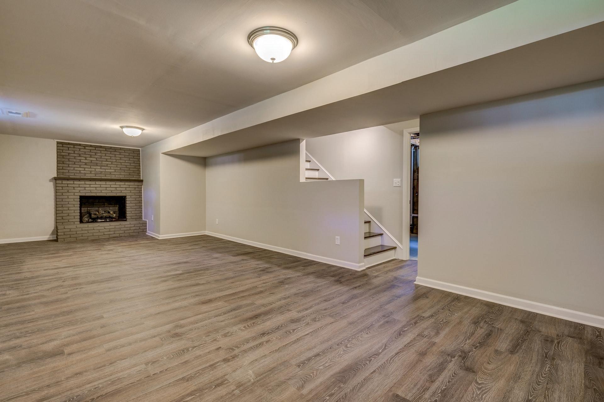 3585 Forester Road Southwest Roanoke, VA 24018 - Photo 22 of 38 an empty room with wooden floor a fireplace and window
