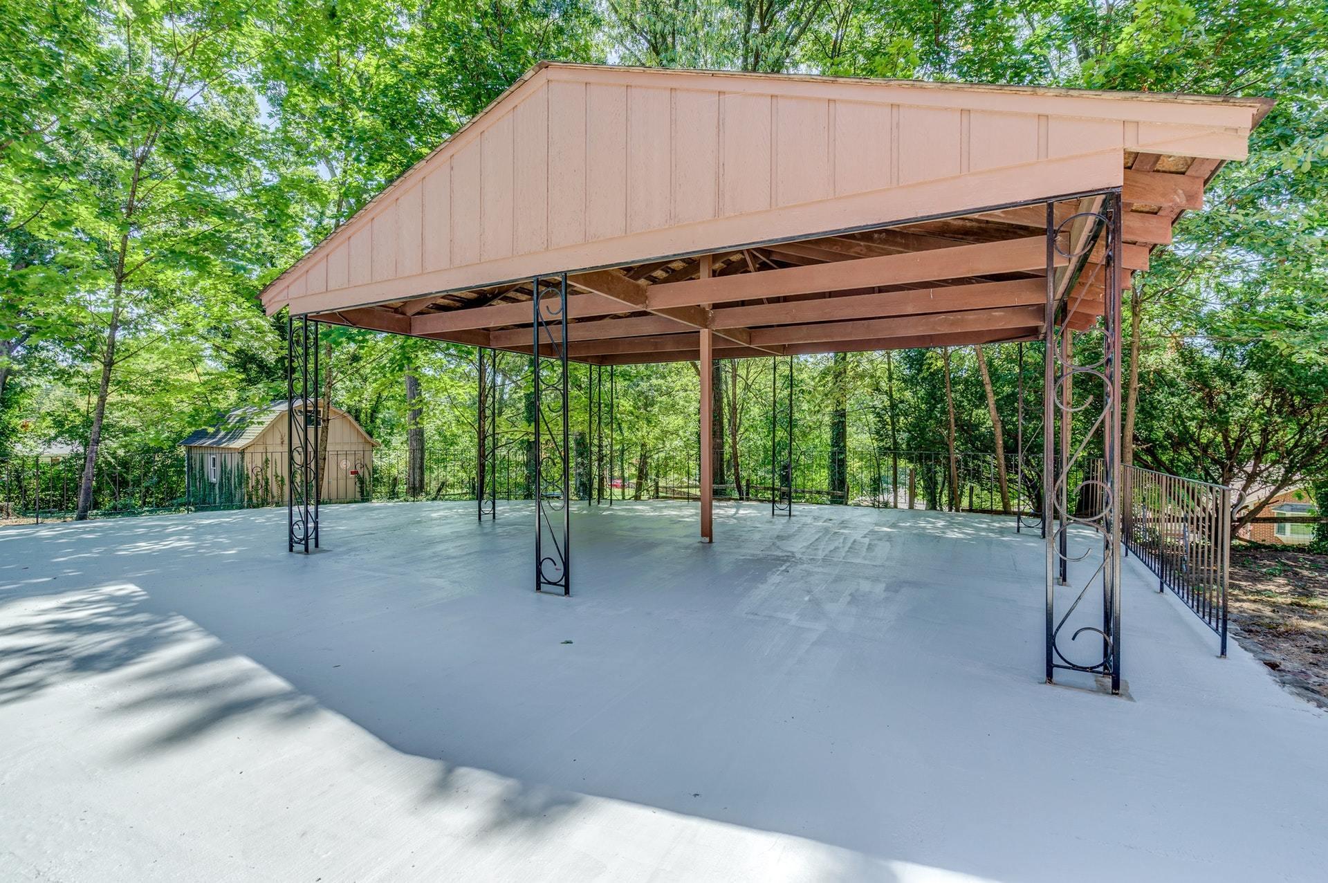 3585 Forester Road Southwest Roanoke, VA 24018 - Photo 30 of 38 a backyard of a house with table and chairs under an umbrella