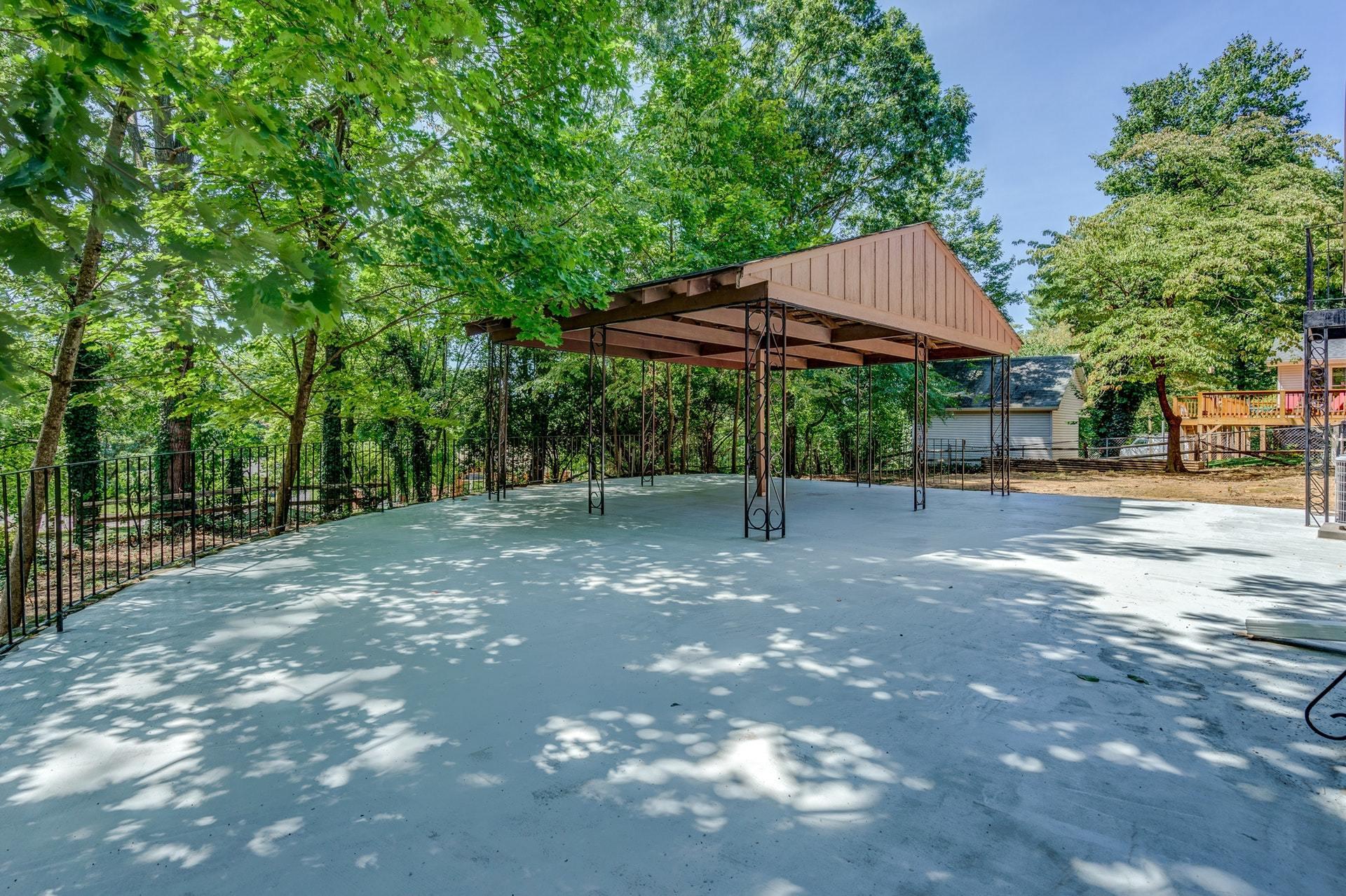 3585 Forester Road Southwest Roanoke, VA 24018 - Photo 31 of 38 a backyard of a house with table and chairs under an umbrella