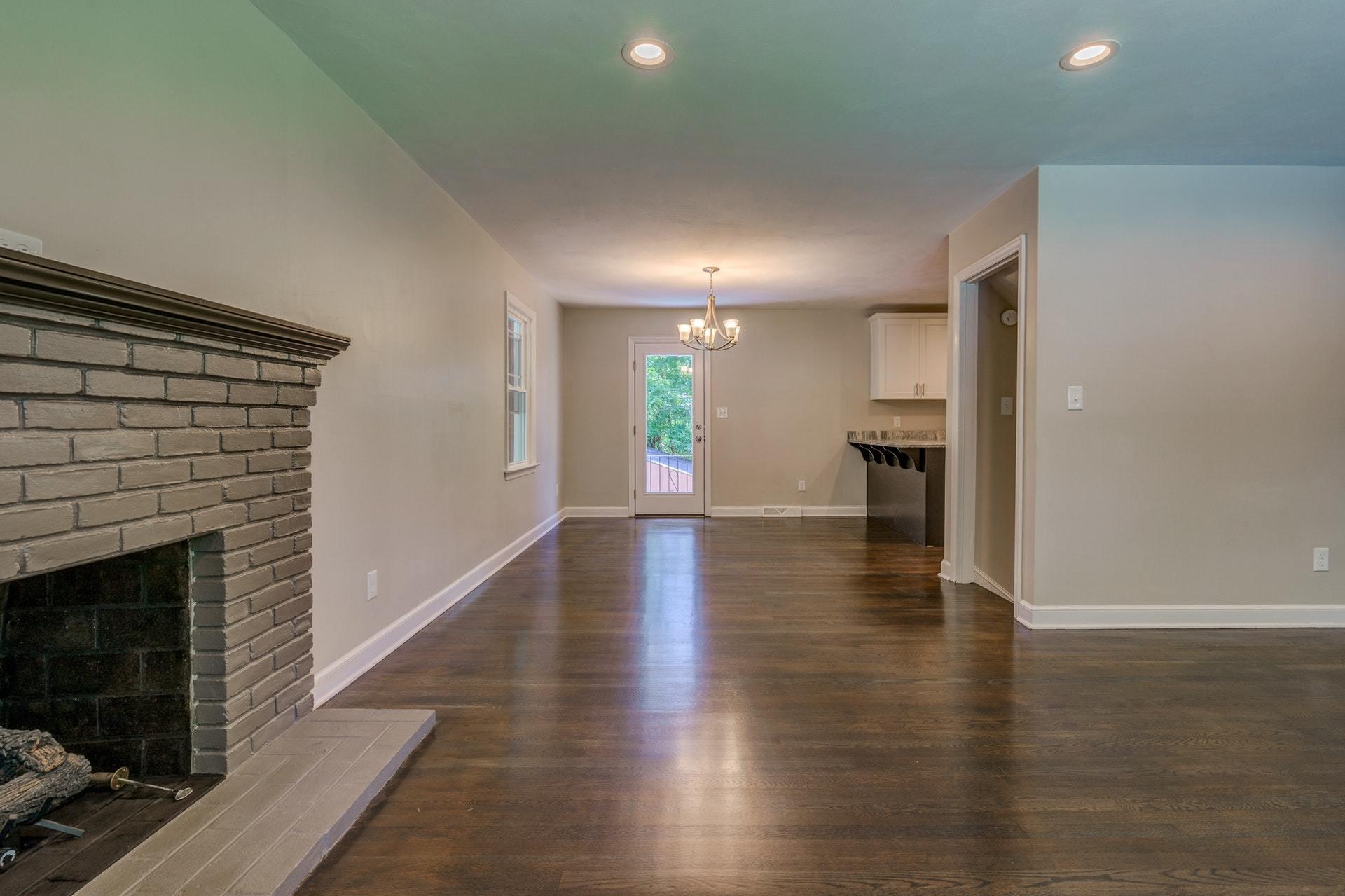 3585 Forester Road Southwest Roanoke, VA 24018 - Photo 7 of 38 a view of an empty room with wooden floor fire place and a fireplace