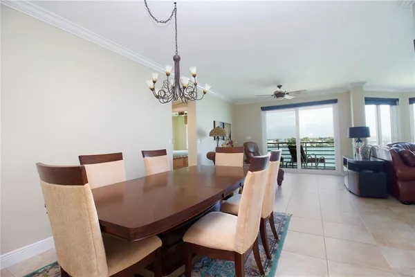 a view of a dining room with furniture wooden floor and chandelier