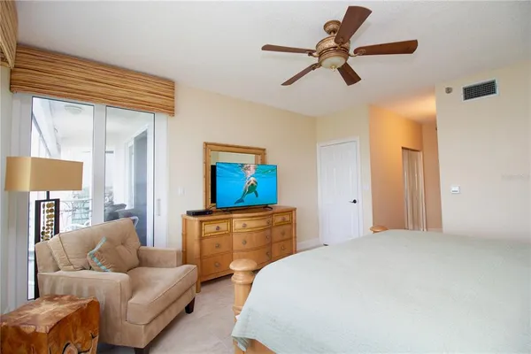 a bedroom with a bed couch and window