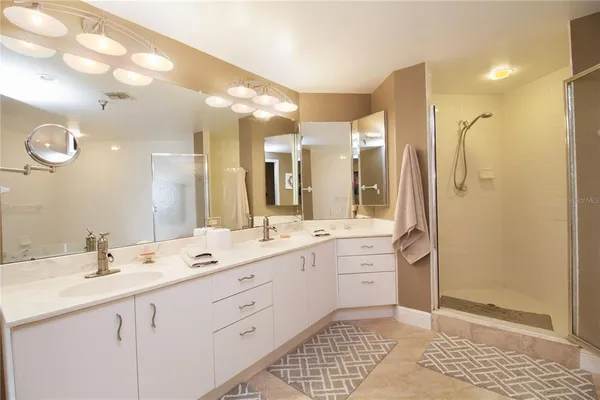 a bathroom with a double vanity sink mirror and double