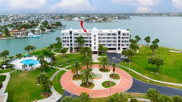 an aerial view of a house with outdoor space and lake view