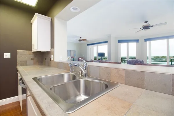 a kitchen with counter top a sink and cabinets