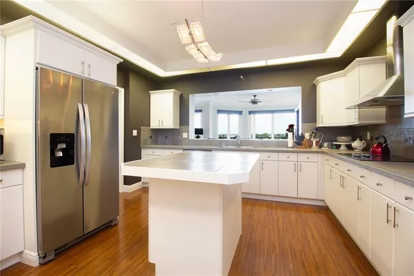 a kitchen with stainless steel appliances granite countertop a refrigerator and a sink