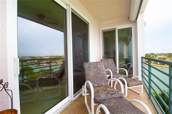 a view of a balcony with a table and chairs