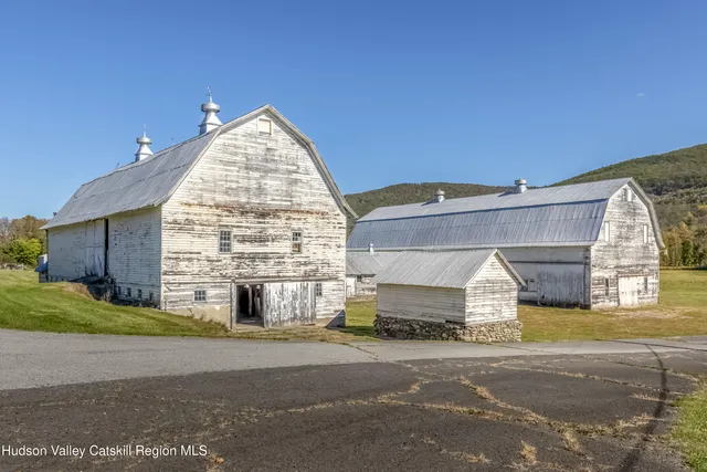 a view of a house with a swimming pool and a yard