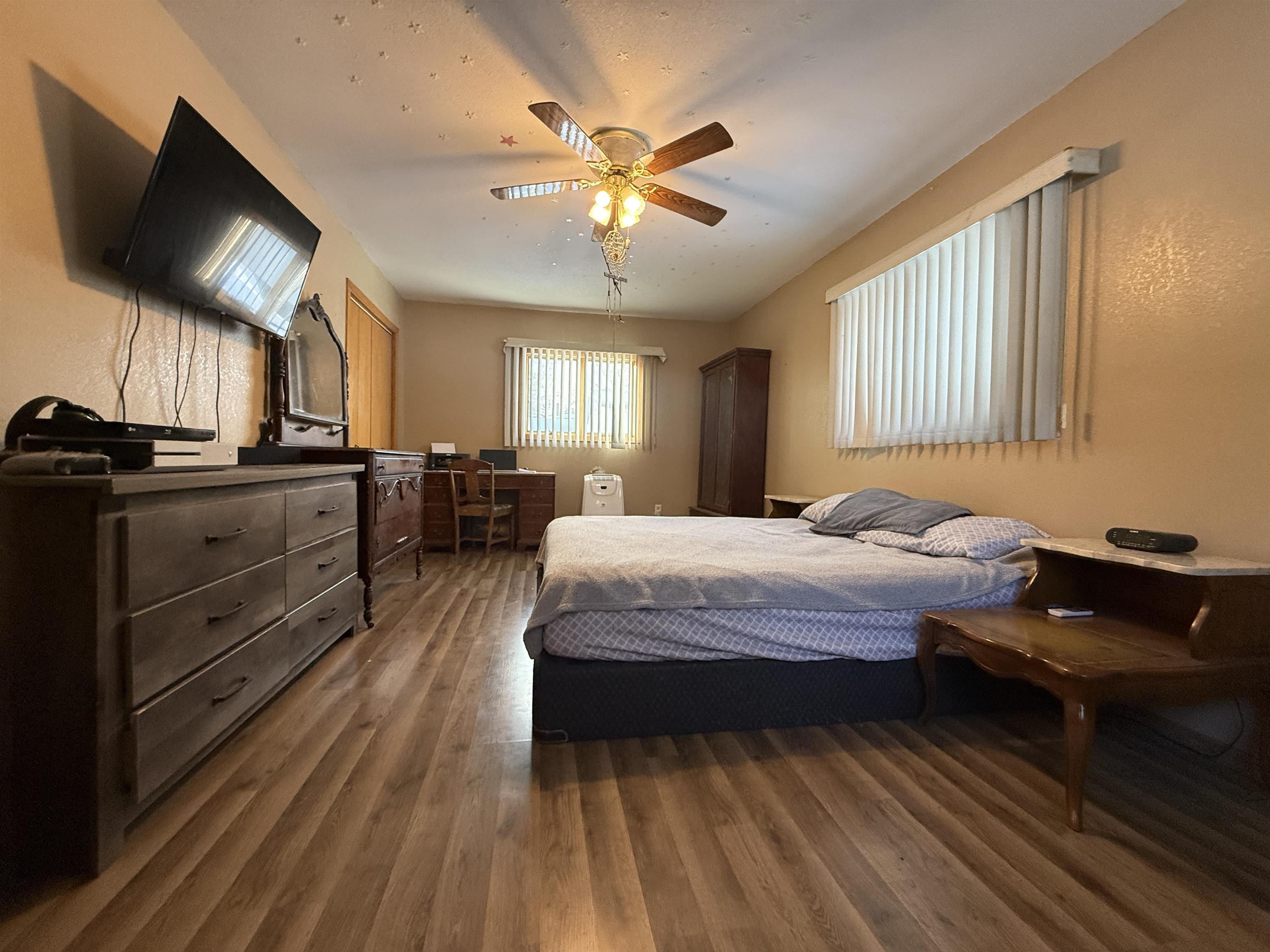 609 8th Street Northwest Chisholm, MN 55719 - Photo 15 of 26 Bedroom with an office area, wood finished floors, and a ceiling fan