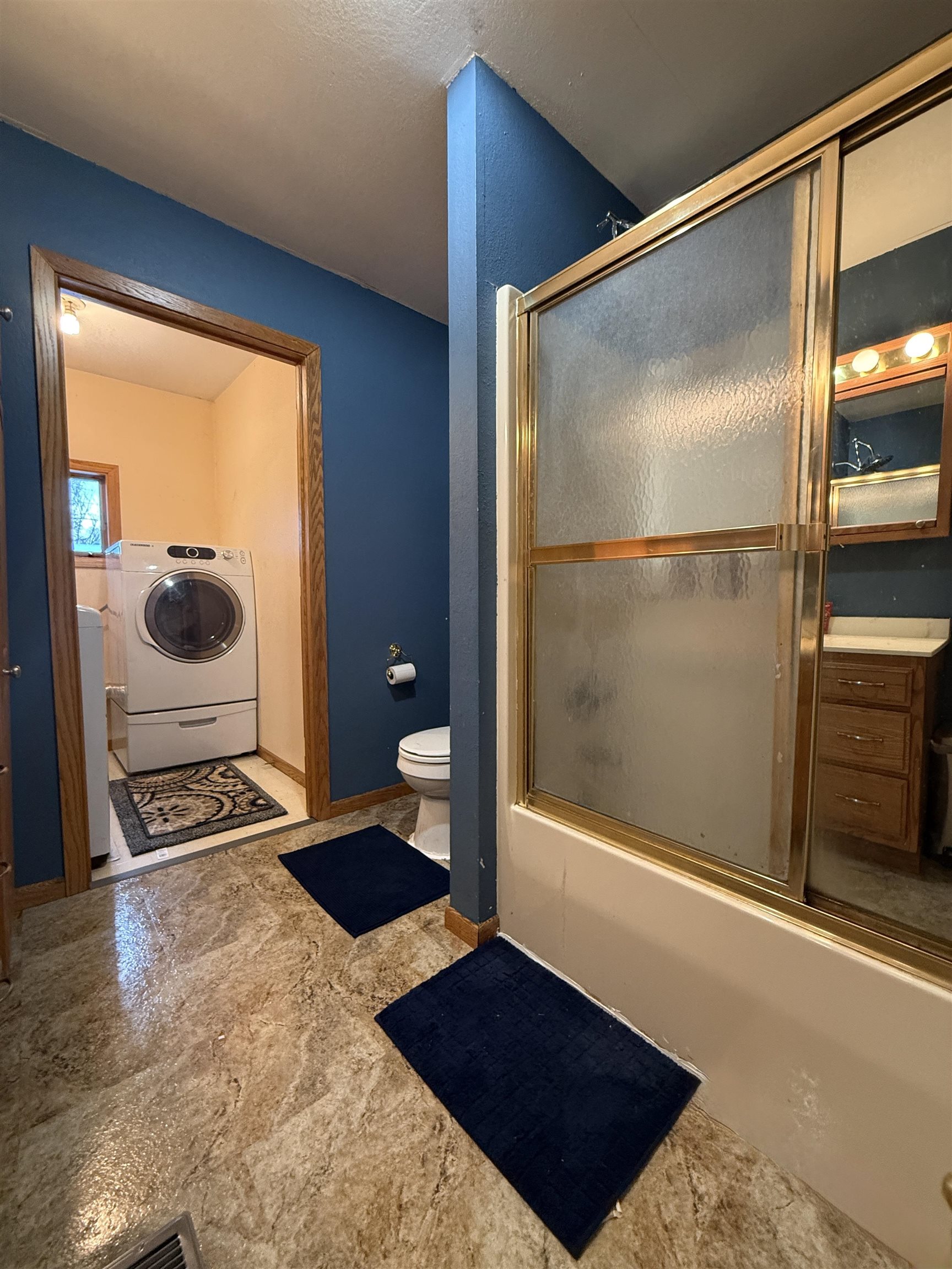609 8th Street Northwest Chisholm, MN 55719 - Photo 18 of 26 Bathroom featuring combined bath / shower with glass door, washer / clothes dryer, and tile patterned floors