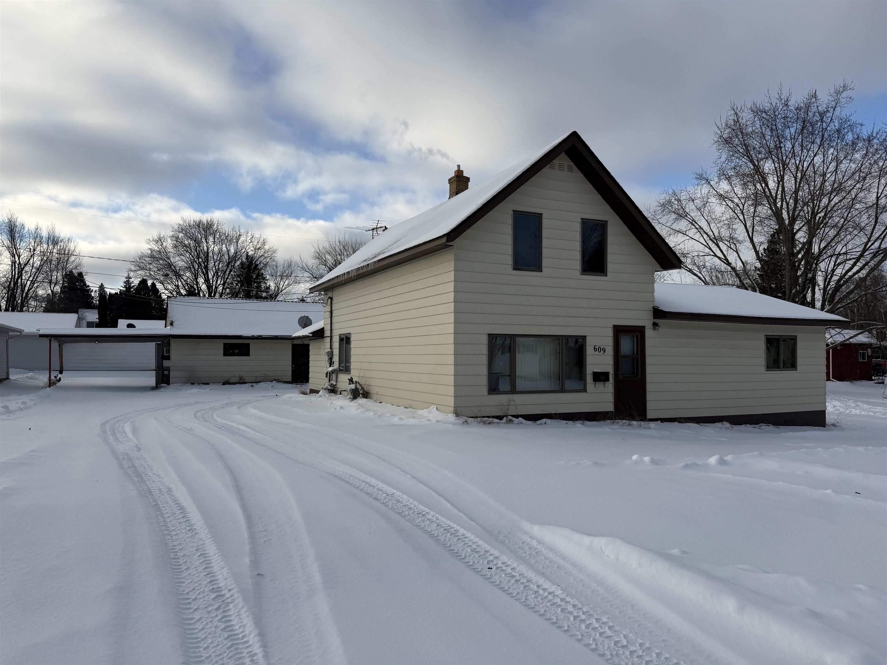 609 8th Street Northwest Chisholm, MN 55719 - Photo 2 of 26 Snow covered rear of property with a chimney