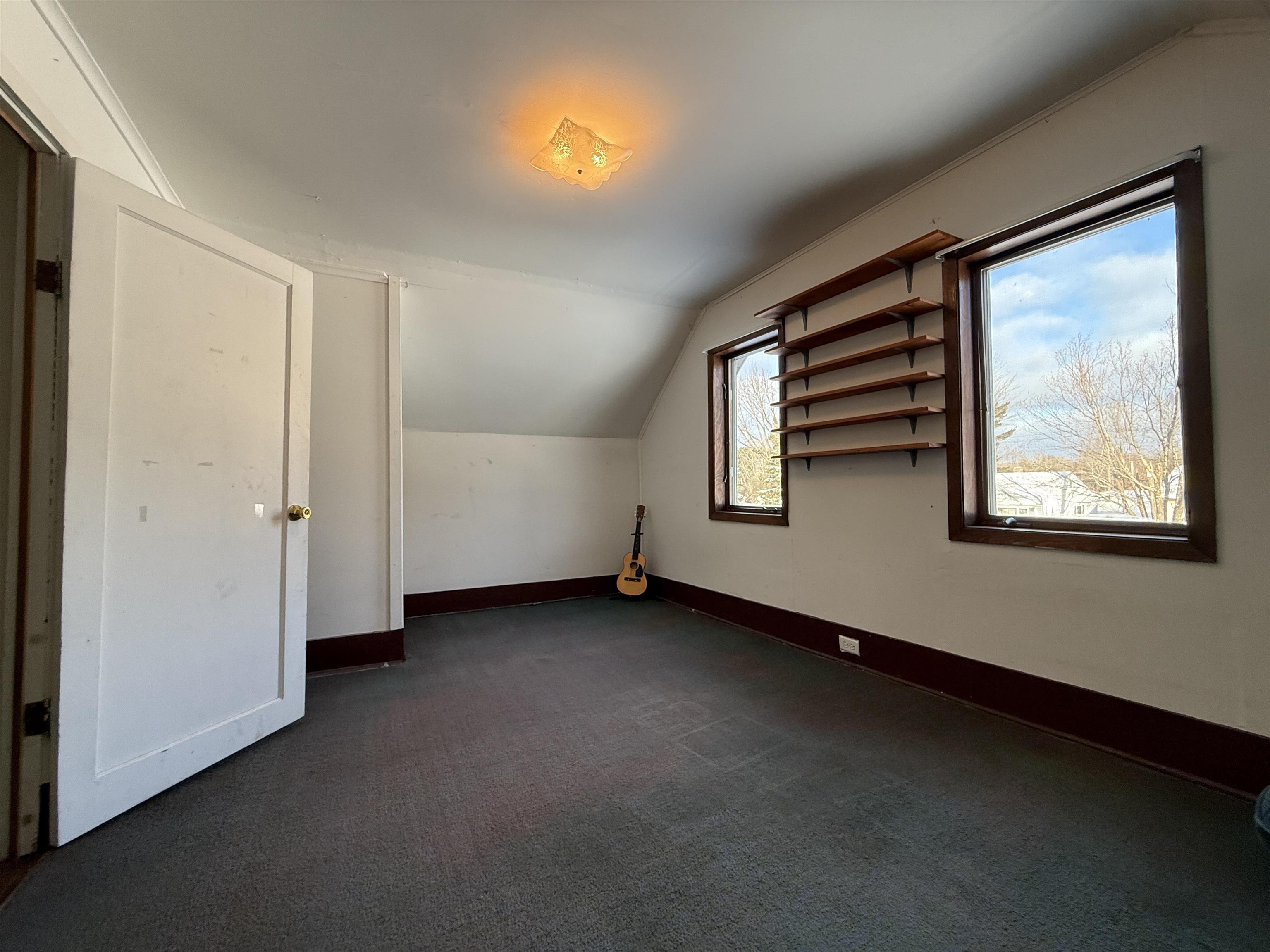 609 8th Street Northwest Chisholm, MN 55719 - Photo 24 of 26 Additional living space with lofted ceiling and dark colored carpet