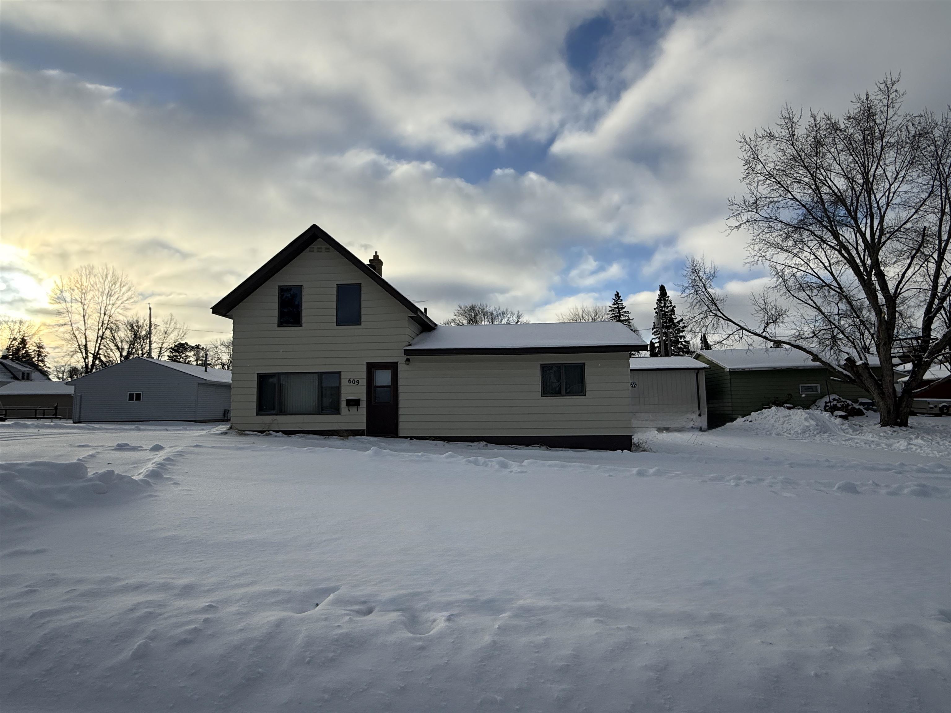 609 8th Street Northwest Chisholm, MN 55719 - Photo 26 of 26 Snow covered house featuring a chimney