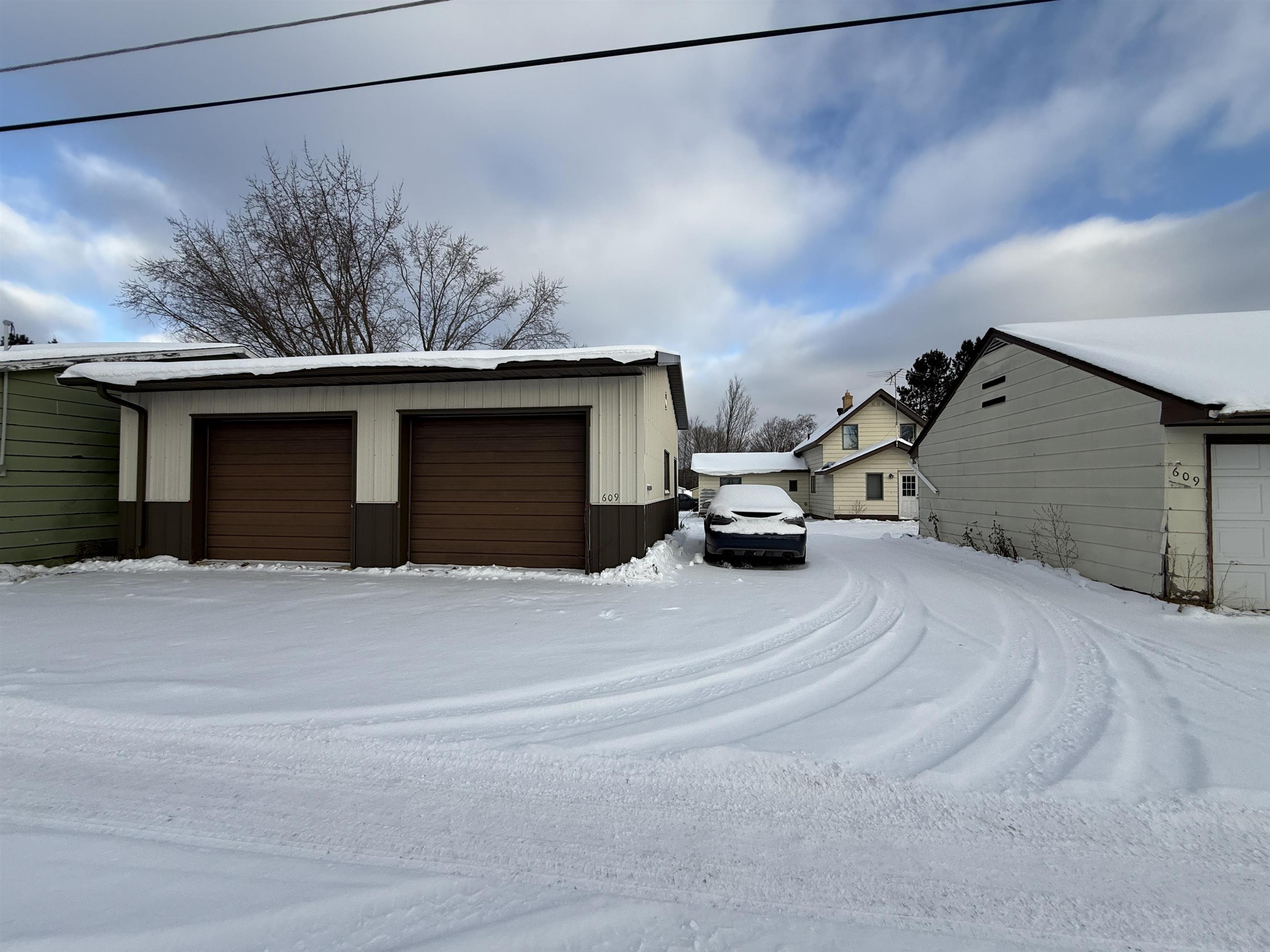 609 8th Street Northwest Chisholm, MN 55719 - Photo 6 of 26 Snow covered garage featuring a garage