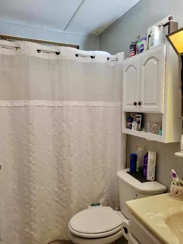 a bathroom with a sink a toilet and vanity