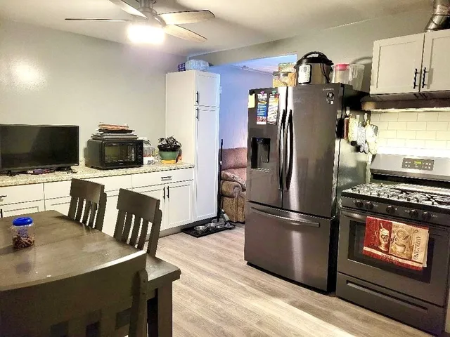a kitchen with kitchen island a refrigerator stove and microwave