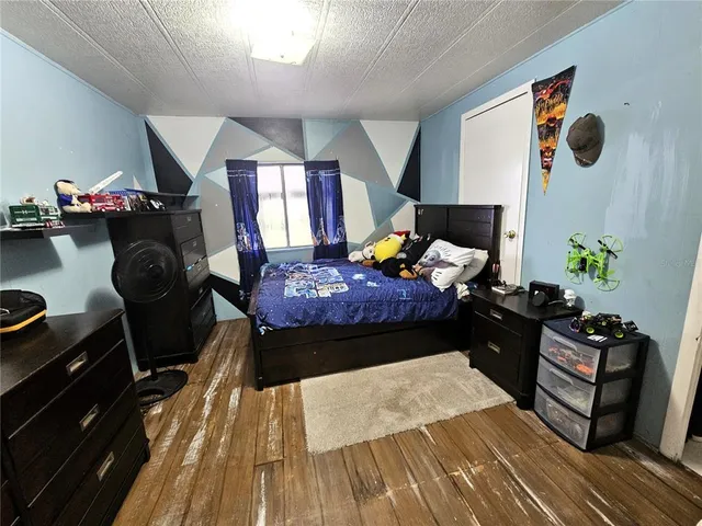 a bed room with a bed and a potted plant