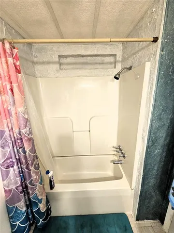 a bathroom with a bathtub and shower