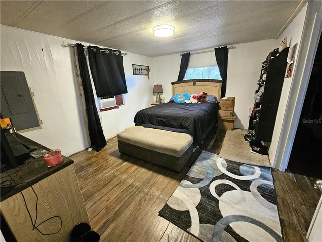a bedroom with a bed and a flat tv screen