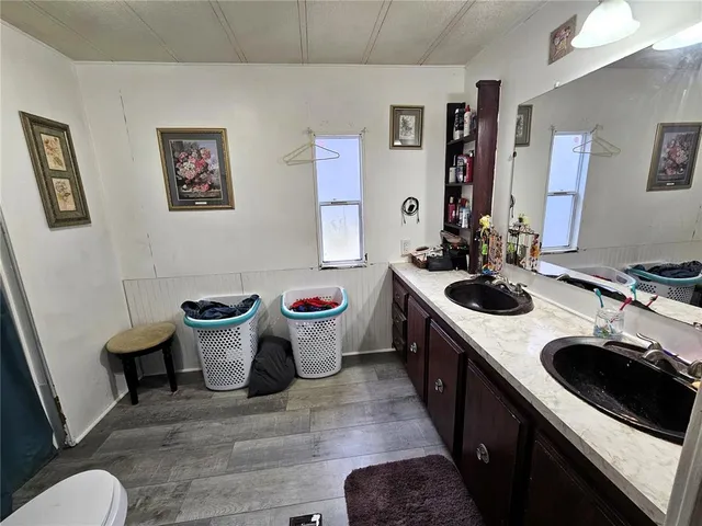a large white kitchen with a stove and a sink