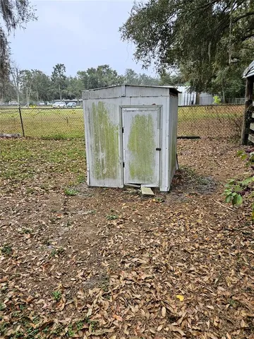 a backyard of a house with lots of green space and lake view