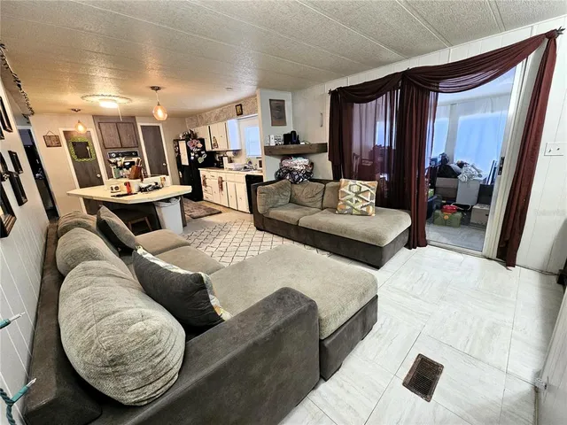 a living room with furniture and a mirror
