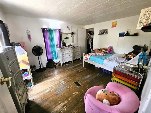 a bedroom with furniture and wooden floor