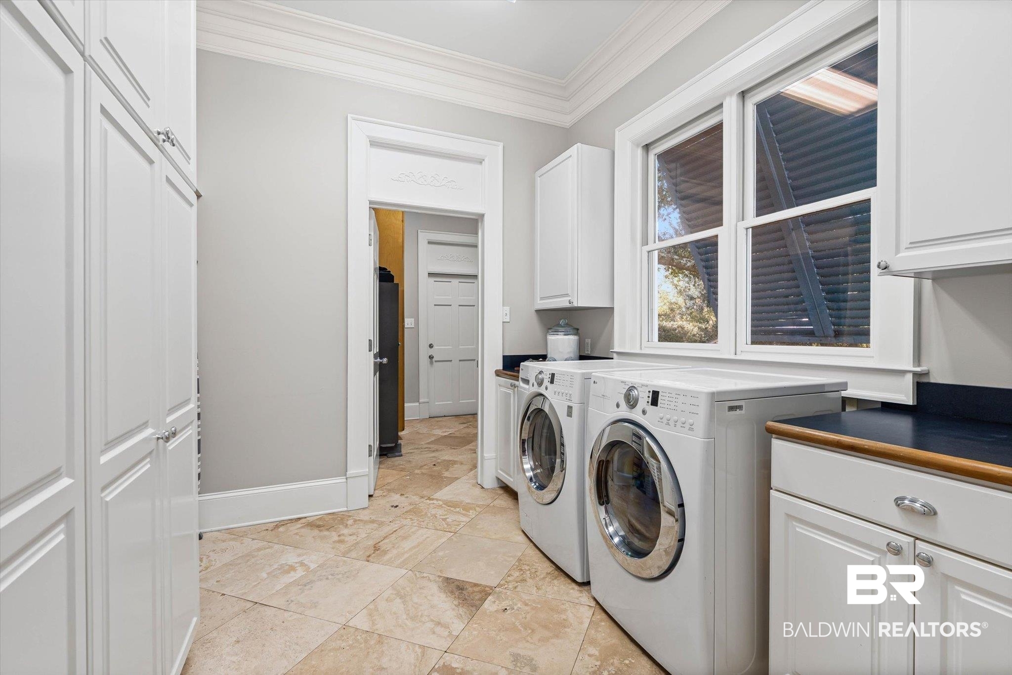 7015 Bay Road Mobile, AL 36605 - Photo 28 of 53 Laundry room with crown molding, cabinet space, and washing machine and dryer
