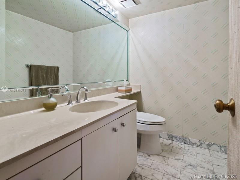 4000 Towerside Terrace, Unit 2302 Miami, FL 33138 - Photo 12 of 24 a bathroom with a granite countertop sink and a toilet
