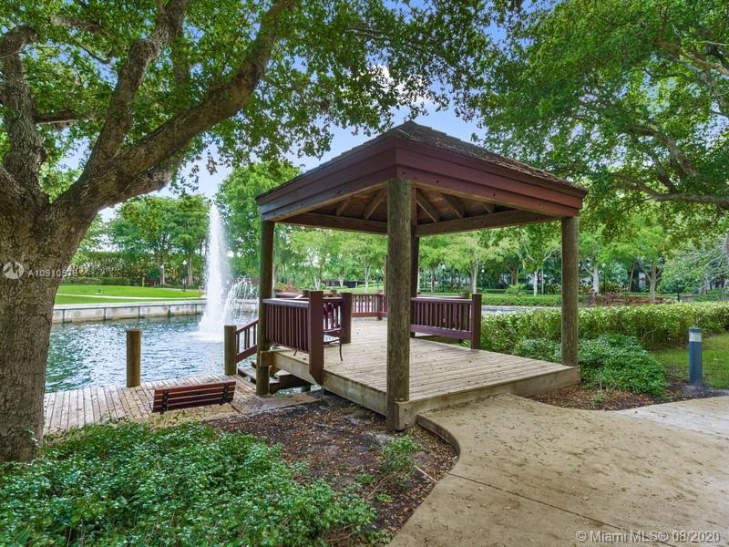 4000 Towerside Terrace, Unit 2302 Miami, FL 33138 - Photo 18 of 24 a view of wooden deck with a table and chairs under an umbrella