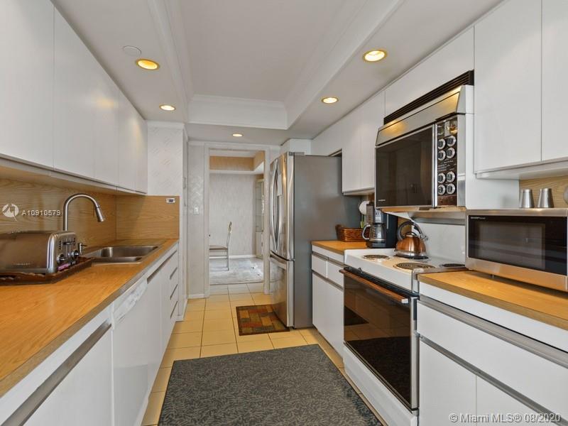 4000 Towerside Terrace, Unit 2302 Miami, FL 33138 - Photo 7 of 24 a kitchen with granite countertop a sink stove and refrigerator