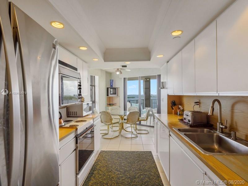 4000 Towerside Terrace, Unit 2302 Miami, FL 33138 - Photo 8 of 24 a kitchen with stainless steel appliances granite countertop sink stove refrigerator and cabinets