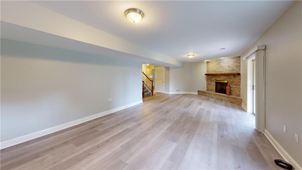 108 Oak Ridge Drive Venetia, PA 15367 - Photo 19 of 42 an empty room with wooden floor fireplace and windows