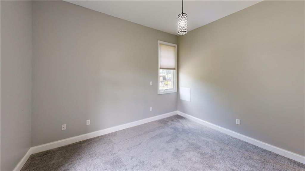 108 Oak Ridge Drive Venetia, PA 15367 - Photo 28 of 42 an empty room with windows and chandelier fan