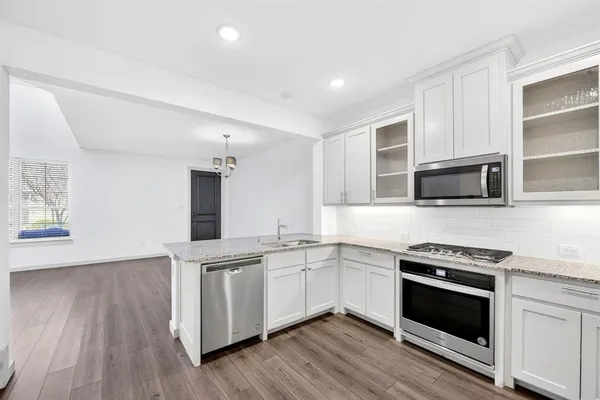 a kitchen with a sink stove and cabinets